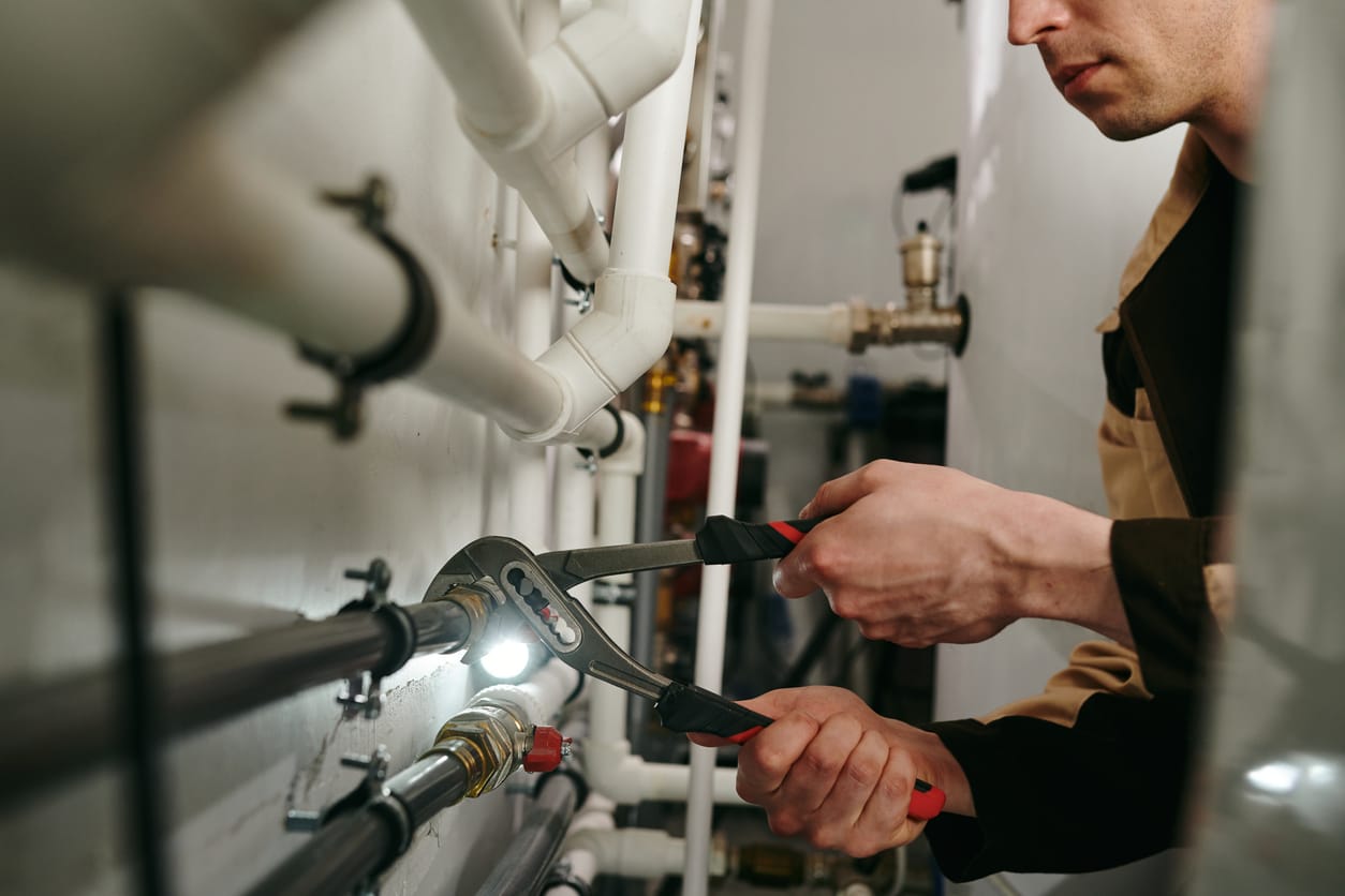 Plumbers maintaining commercial plumbing pipes in Maitland