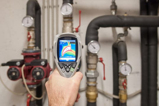 Plumber using a thermal imaging camera to inspect pipes in Maitland