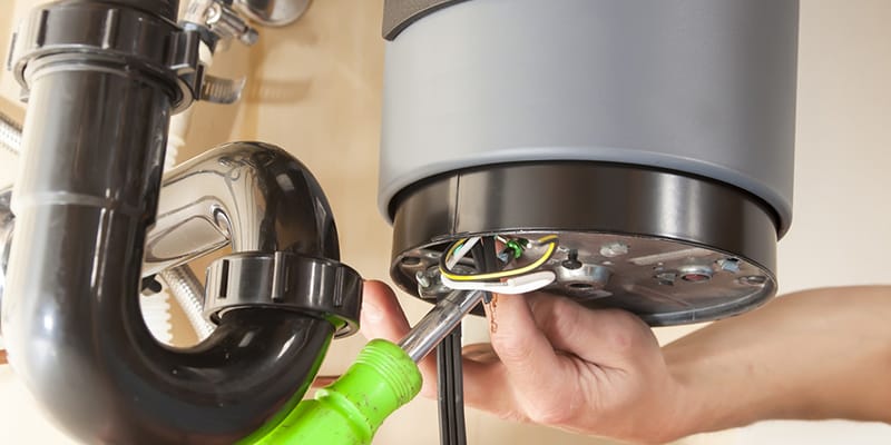 Technician repairing the heating element of a water heater in Maitland