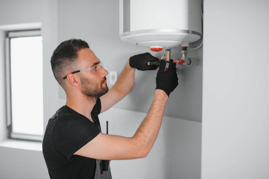 Technician performing water heater maintenance in Maitland